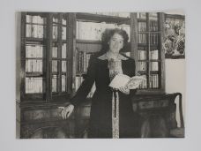SIGNED ORIGINAL PHOTOGRAPH OF ENID BLYTON IN HER LIBRARY